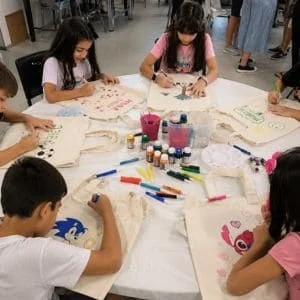 Crianças em oficina infantil sacolas ecobag decorando ecobags coloridas
