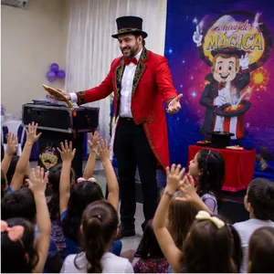 Mágico realizando truque para crianças em aniversário infantil